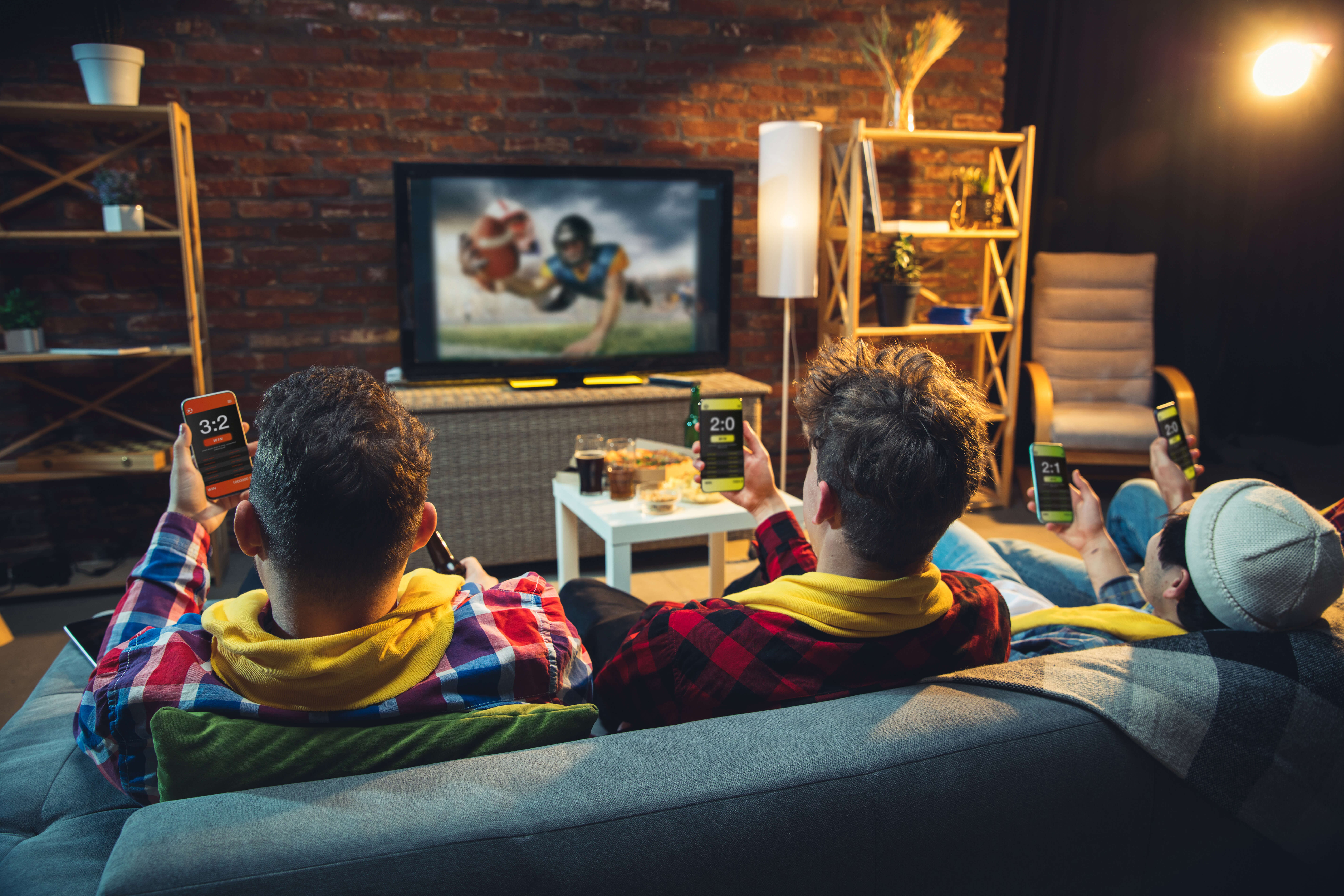 group of friends watching  sports on tv