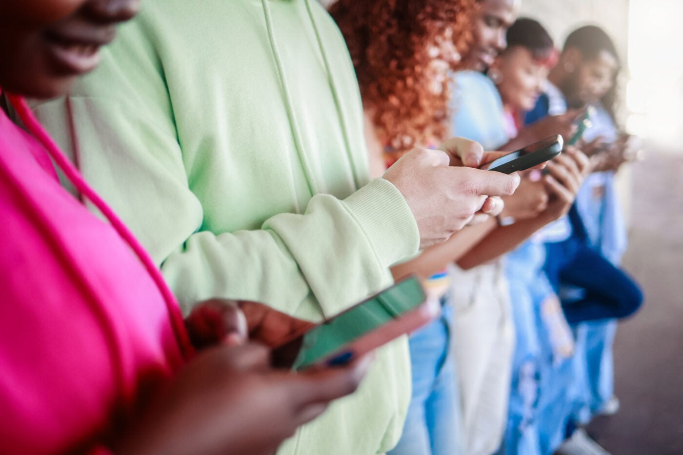 A group of people looking at their phones simultaneously.