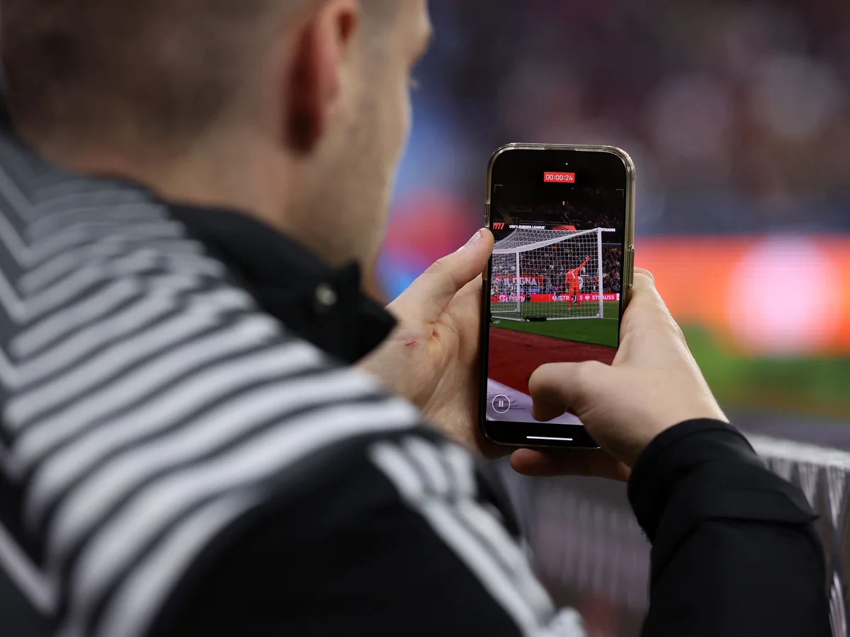 Fan recording football match