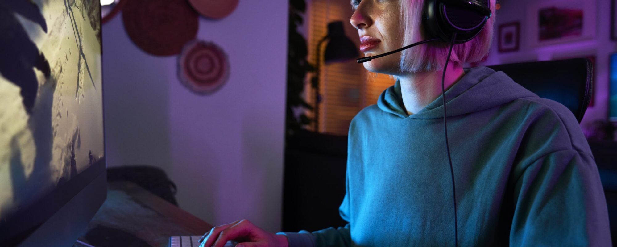 focused woman gaming online at home at night