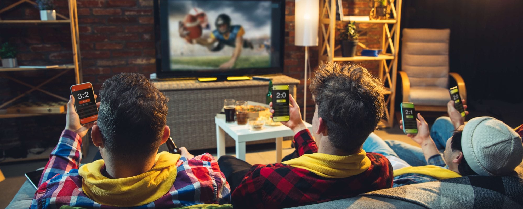 group of friends watching sports on tv