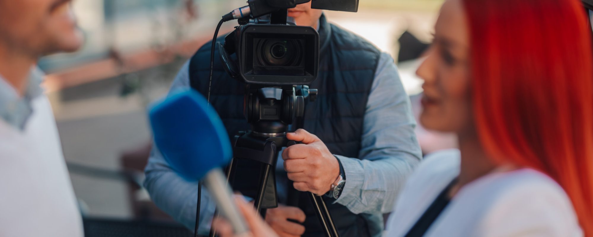 Professional crew filming an interview with businessman for a news story or documentary