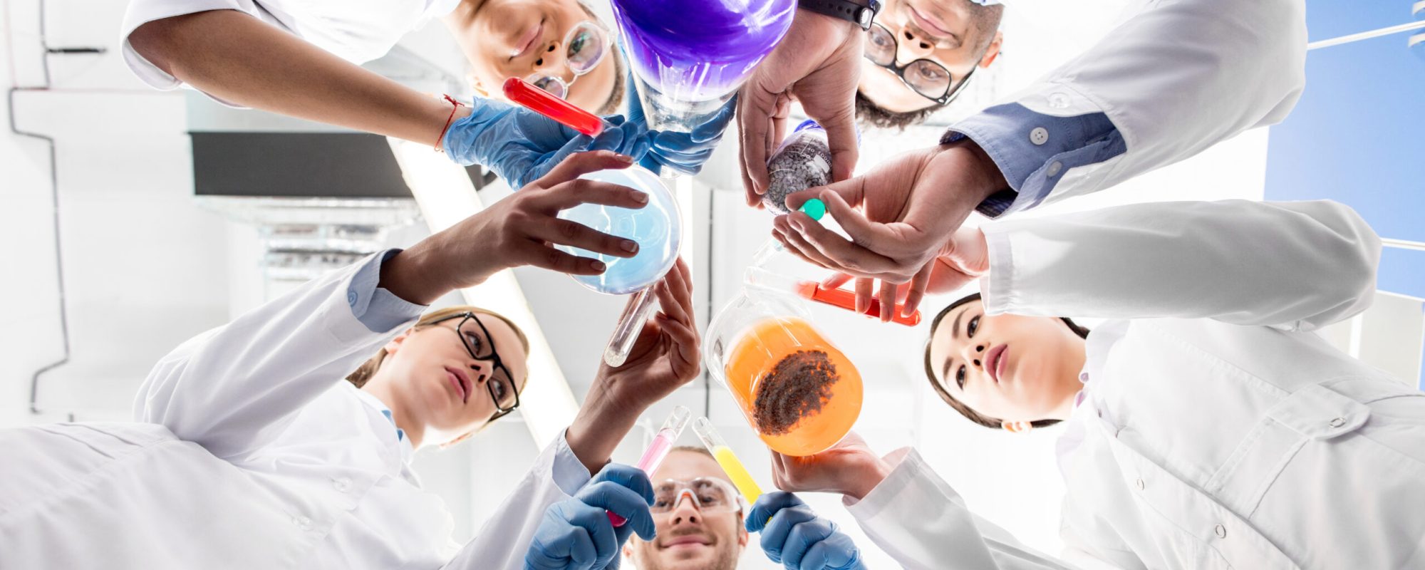 low angle view of scientists holding various test tubes