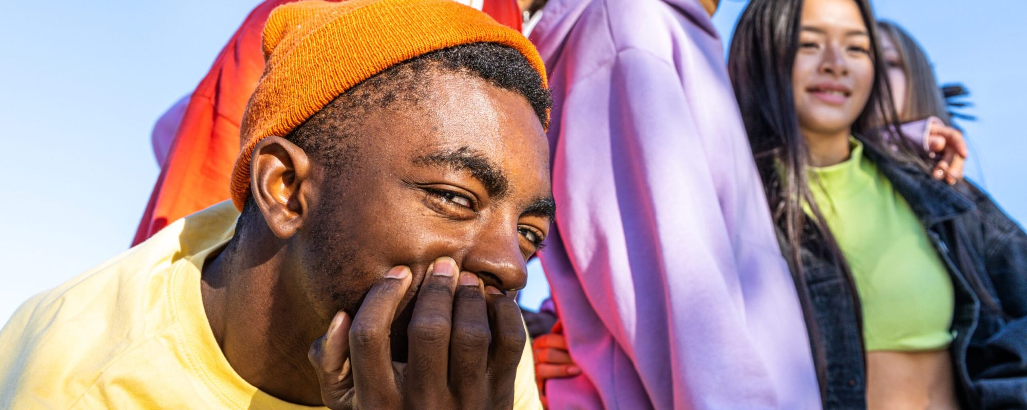 Multicultural group of young friends bonding outdoors and having fun - Stylish cool teens gathering at urban skate park