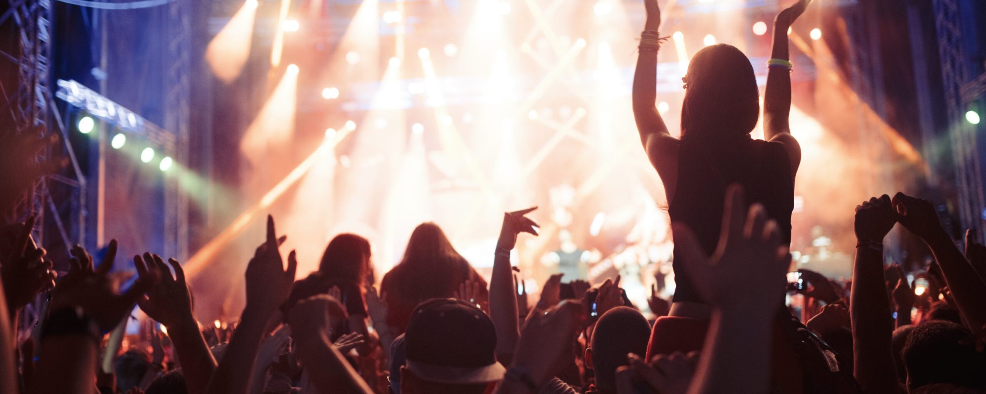 Portrait of happy dancing crowd enjoying at music festival
